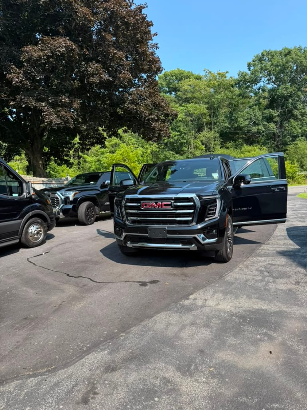 GMC Yukon Denali stretch limo front three-quarter exterior view