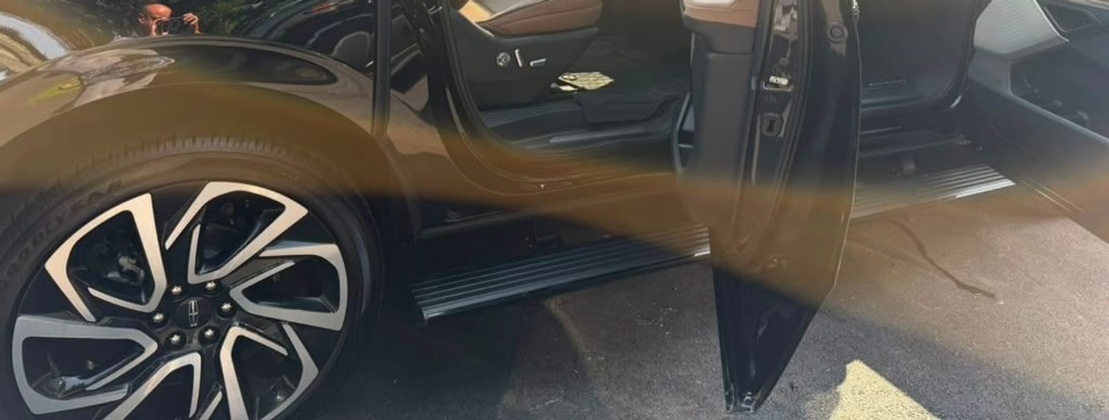 Lincoln Navigator Black Label SUV limo, distinctive split-spoke wheel and open door, part of the NJ.Limo fleet