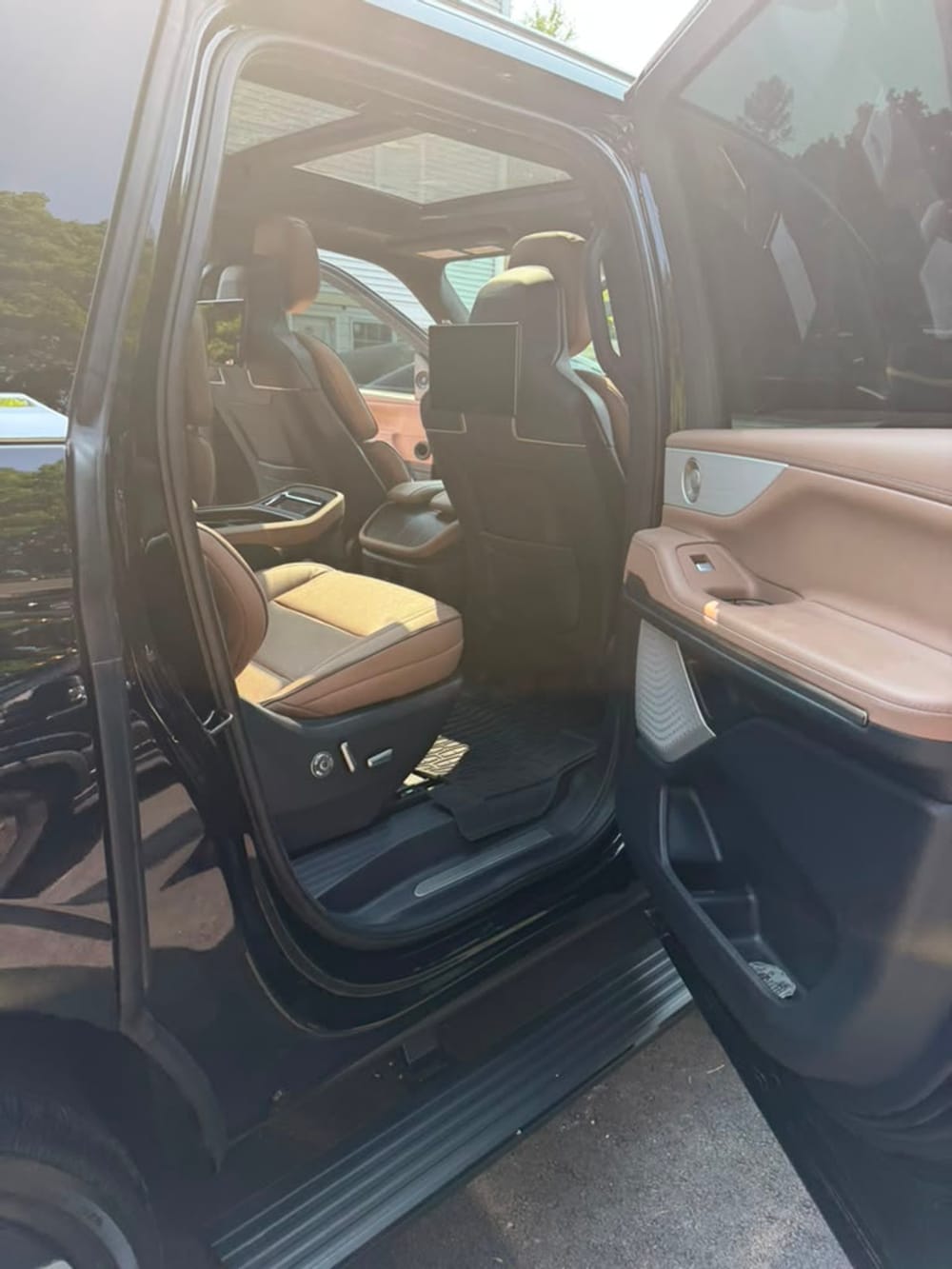 Lincoln Navigator SUV limo captain's chair second row seating with overhead screens and moonroof