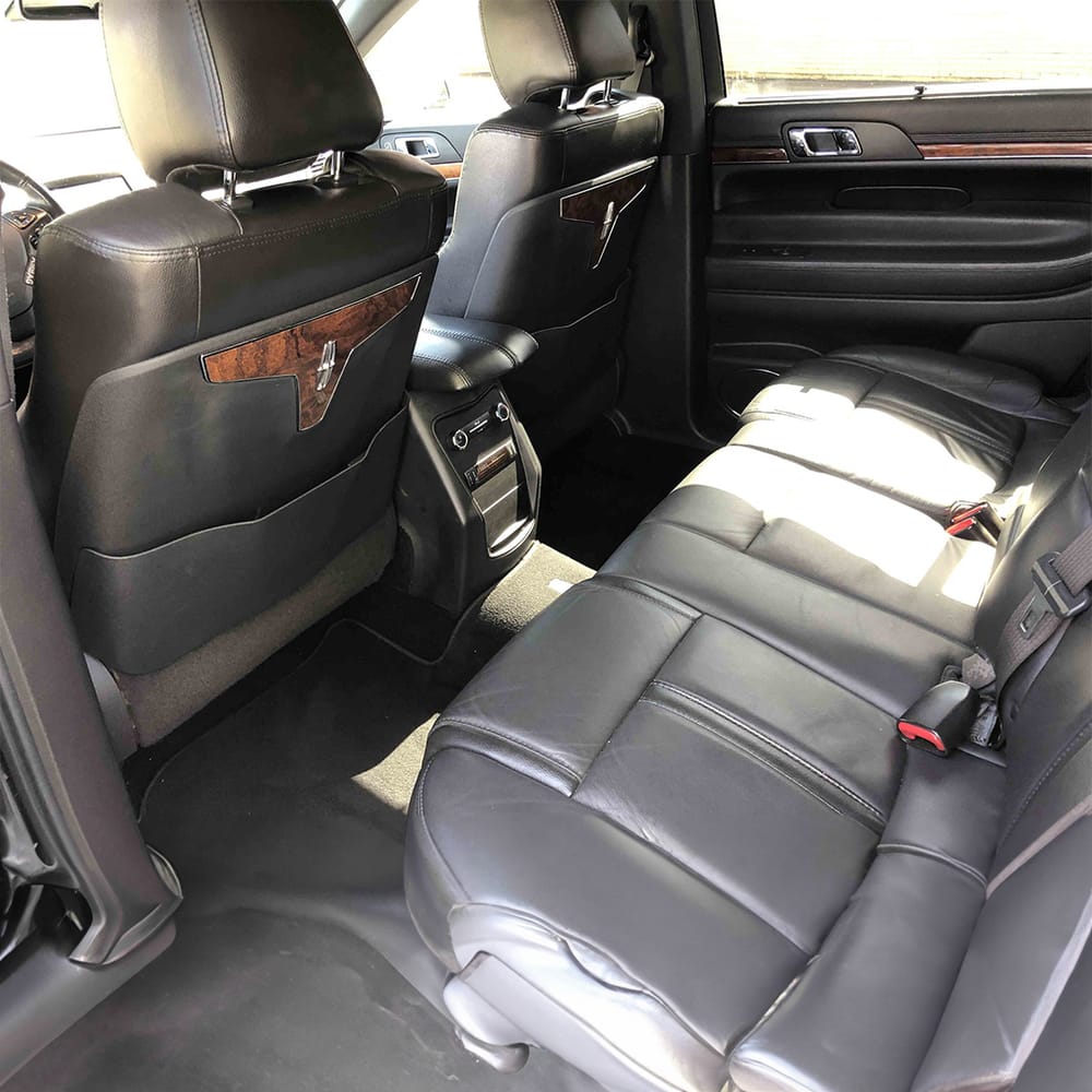 Lincoln luxury sedan rear seating with fold-down armrest and console controls