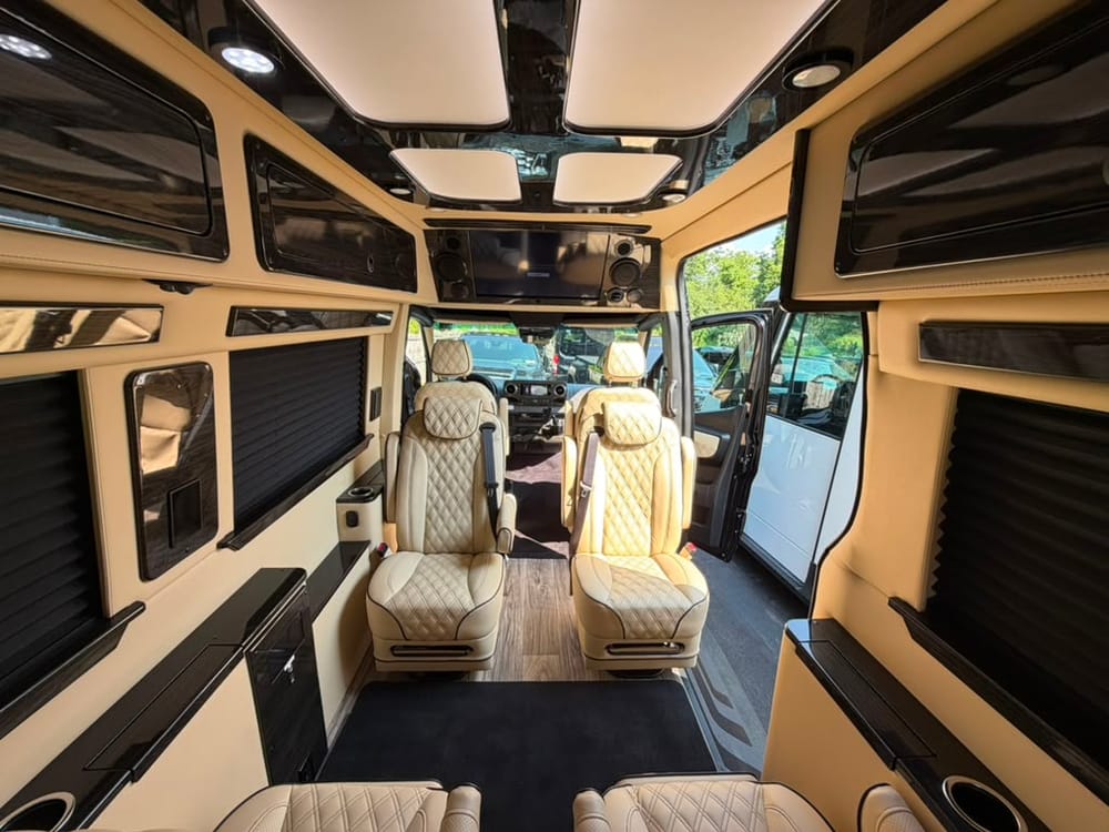 Mercedes-Benz Sprinter van rear cabin with diamond-stitched leather captain's chairs and overhead skylights